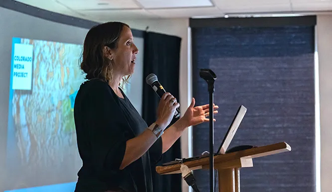 Melissa Davis speaking at a podium