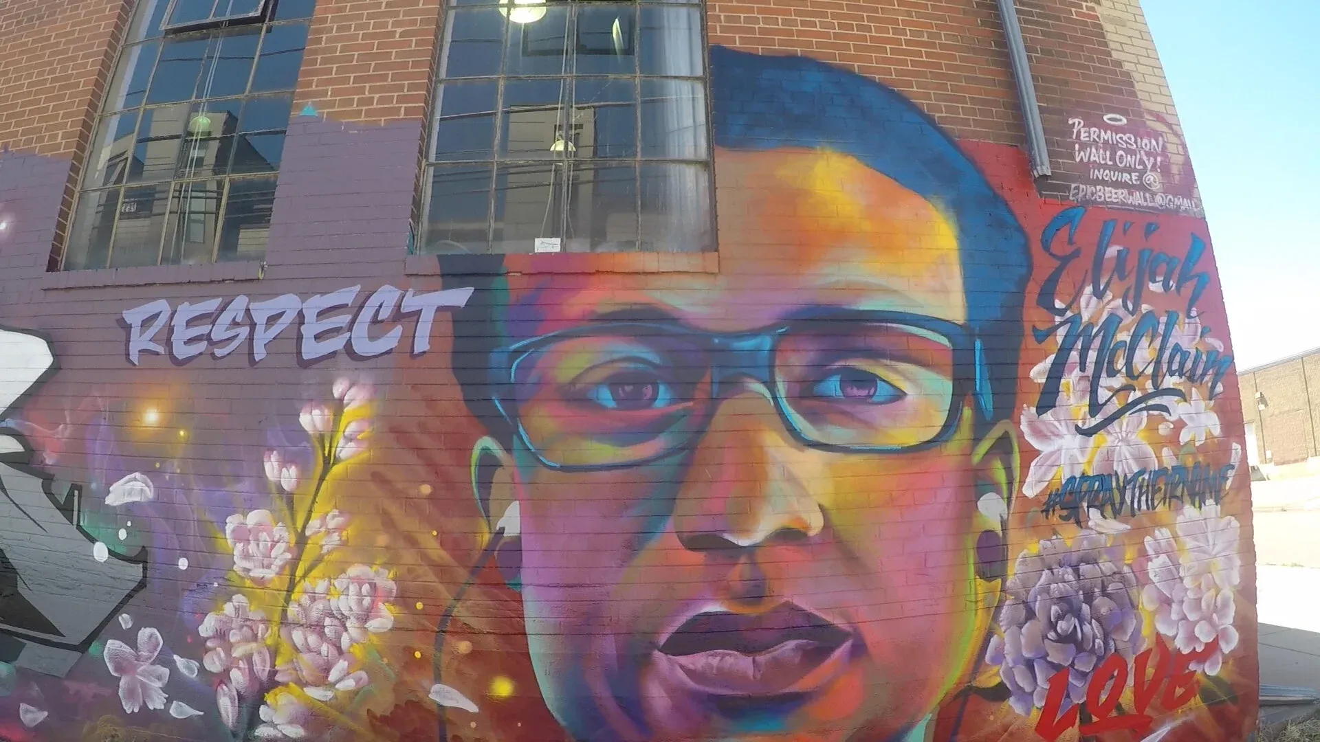 A mural of Elijah McClain on the side of a building