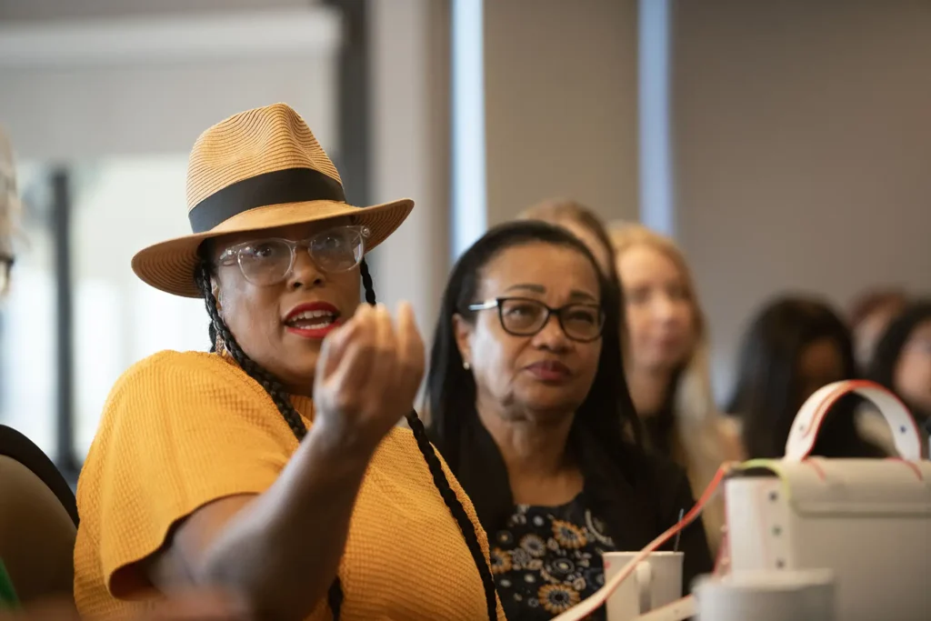 A woman speaks at a table at the CMP annual convention