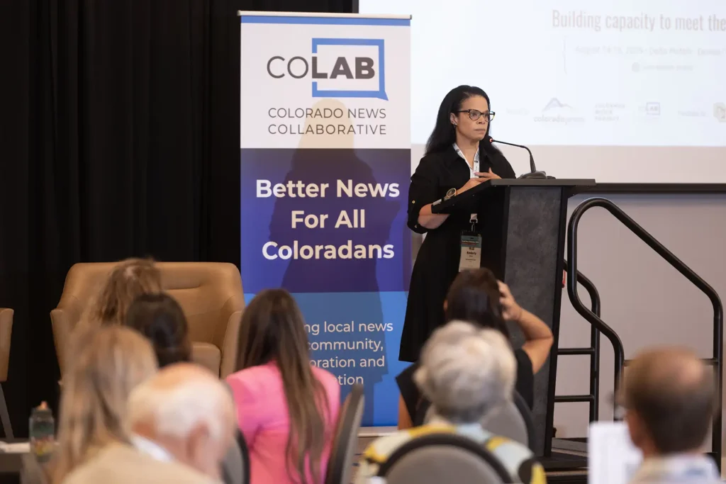 Kimberly Spencer speaks at a podium in front of a crowd at the CPA Annual Convention